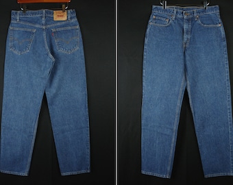 May include: A pair of blue denim jeans with a classic straight leg fit. The jeans have a button fly and five pockets.