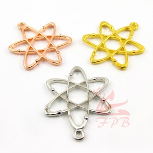 May include: Three atom-shaped metal charms in gold, silver, and rose gold. Each charm has a loop at the top for attaching to a necklace or bracelet.