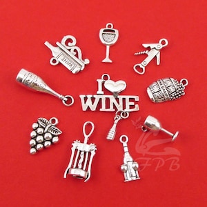 May include: A set of ten silver-toned metal charms with wine-themed designs. The charms include a wine bottle, a wine glass, a corkscrew, a grape cluster, a wine barrel, and a charm that says "I love wine".