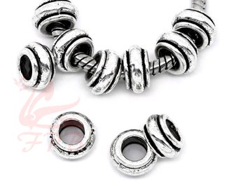 May include: Silver-toned metal beads with a grooved design. The beads have a hole in the centre for threading onto a bracelet or necklace.