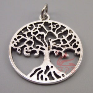 May include: Silver-toned metal pendant in the shape of a tree of life. The pendant is circular and features a detailed design of a tree with branches and roots.