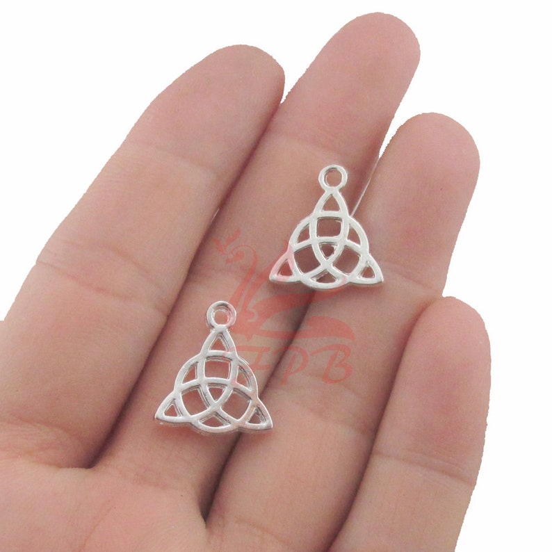 May include: Two silver-toned Celtic knot charms in the shape of a triangle. The charms have a loop at the top for attaching to jewelry.