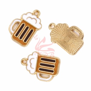 May include: Three gold-colored metal charms shaped like beer mugs. One mug has a white foam top and brown liquid, another has a white foam top and brown liquid, and the third is a solid gold mug with a sunburst design.
