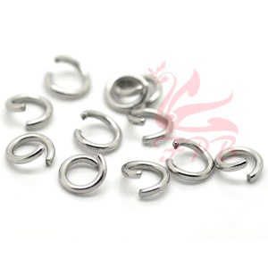 May include: A close-up of a group of silver jump rings. The rings are small and round, and they are ideal for jewellery making.