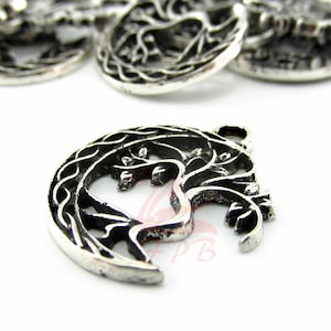 May include: Silver charm pendant featuring a tree of life design with intricate branches and leaves, set within a crescent moon shape.