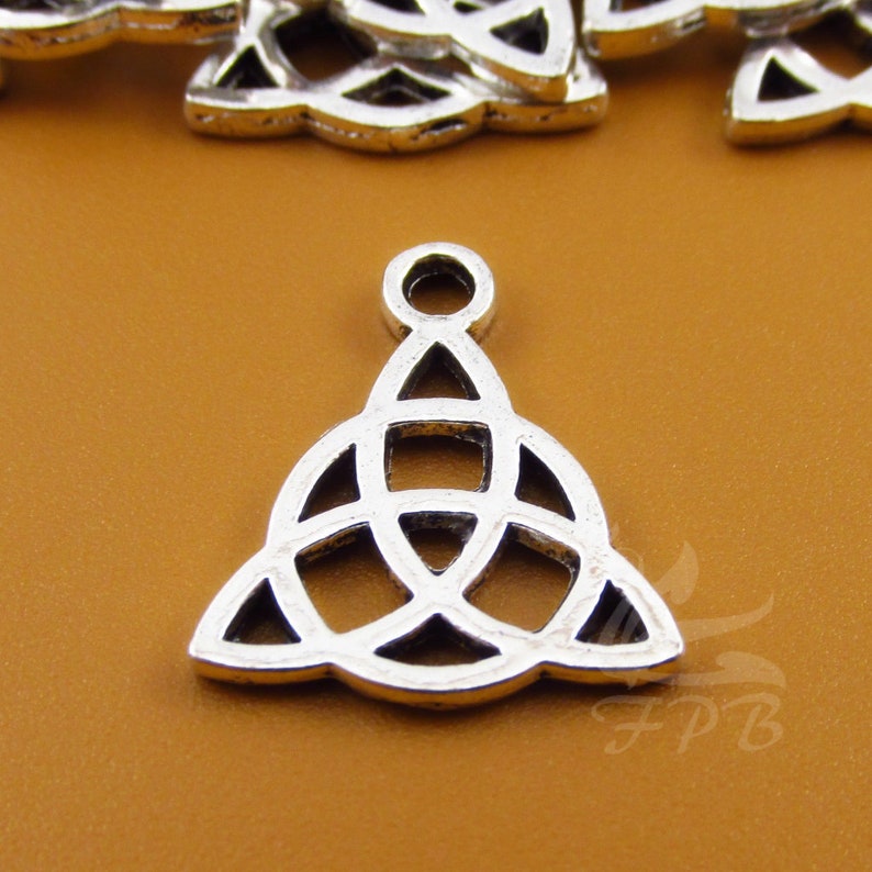 May include: Silver charm with a Celtic knot design. The knot is a triangle shape with three interlocked circles.