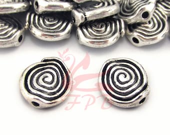 May include: Silver metal beads with a spiral design. The beads have a hole in the center for stringing.