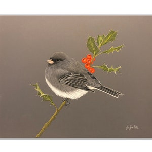 May include: A framed watercolor painting of a small gray bird perched on a branch with holly berries. The bird has a white belly and is set against a muted gray background. The artwork is signed in the lower right corner.