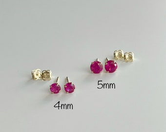 May include: Two pairs of ruby red stud earrings, one pair is 4mm and the other is 5mm.