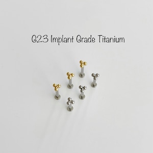 May include: Six titanium body jewellery pieces with a three-ball design. The jewellery is available in gold and silver.