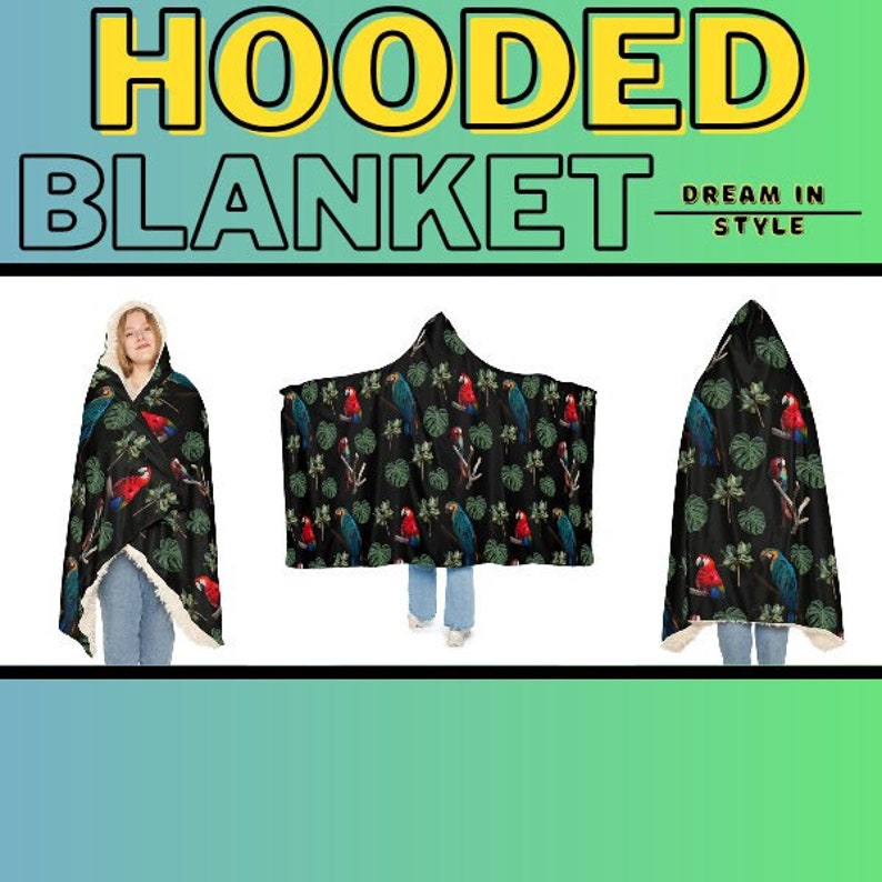 May include: A hooded blanket with a black background and a pattern of red and blue parrots and green leaves. The blanket has a hood and a soft, white lining. The words "HOODED BLANKET" are at the top of the image.