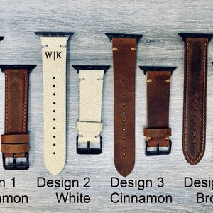 May include: Five different leather watch bands for Apple Watch. The bands are in various colors, including brown, white, and cinnamon. The bands are all made of leather and have a stitched design. The bands are labeled with the text "Design 1 Cinnamon", "Design 2 White", "Design 3 Cinnamon", "Design 4 Brown".