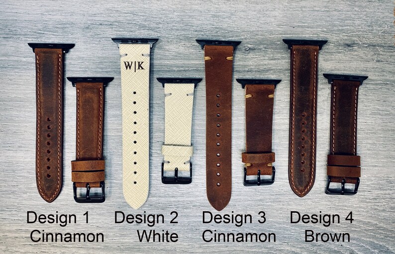 May include: Five different leather watch bands for Apple Watch. The bands are in various colors, including brown, white, and cinnamon. The bands are all made of leather and have a stitched design. The bands are labeled with the text "Design 1 Cinnamon", "Design 2 White", "Design 3 Cinnamon", "Design 4 Brown".