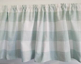 May include: A green and white checkered valance with a gathered top. The valance is made of a lightweight fabric and has a subtle sheen.
