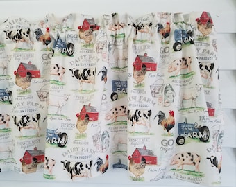 May include: A white fabric valance with a farmhouse theme. The valance features a repeating pattern of farm animals, including cows, pigs, chickens, and roosters. The pattern also includes red barns, farm equipment, and text that says "Dairy Farm Artisan Produce", "Fresh is Best Buy Local", and "Go Organic".