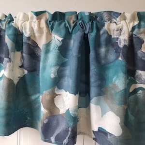 May include: Teal, white, and gray floral patterned valance with a gathered ruffle at the top.