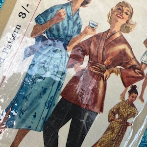 May include: A set of three ceramic mugs with a speckled, matte finish. The mugs are in shades of cream, light gray, and dark gray. Each mug has a simple, minimalist design, perfect for coffee or tea.