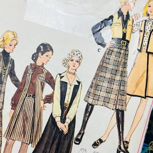 May include: A vintage sewing pattern envelope labelled 5949, size 12 1/2, bust 35. The front displays illustrations of five outfits featuring vests, skirts, and trousers in various plaid and solid patterns, along with technical line drawings.