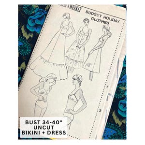 May include: A sewing pattern envelope titled Woman's Weekly Budget Holiday Clothes featuring illustrations of dresses and a bikini. The text indicates bust 34-40 inches, uncut, bikini and dress. The paper envelope is white with black line drawings.