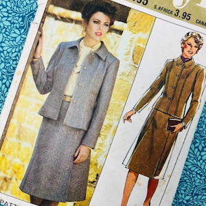 May include: Vintage sewing pattern showing a woman in a grey skirt suit. The pattern includes a jacket and skirt design, with the text "JEUNE FEMME" and "Skirt lining". The pattern is on a blue floral patterned background.