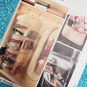 May include: A McCall's Crafts pattern showing a closet organiser and car seat organiser. The closet organiser has multiple clear pockets and hanging compartments. The car seat organiser has pockets for magazines, cards, and other items. The pattern is on a white background.