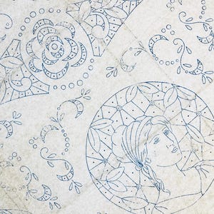 May include: A white fabric sheet featuring blue ink transfer patterns. The design includes a circular medallion with a profile of a person, a large rose, geometric shapes, and various floral vine motifs. The word Sheet is printed on the left side.