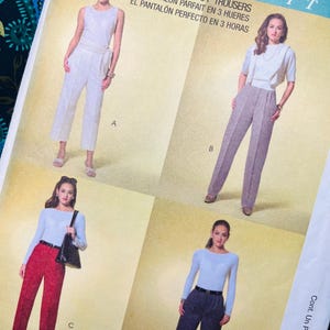 May include: A McCall's sewing pattern envelope titled 3 Hour Perfect Trousers featuring four variations of trousers labeled A, B, C, and D. View A shows white trousers, B shows grey trousers, C shows red trousers, and D shows dark grey trousers.