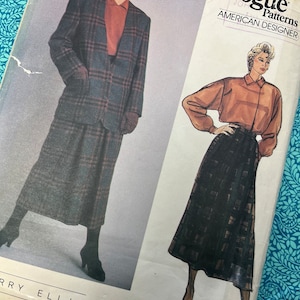 May include: Vogue American Designer pattern featuring a suit and skirt design. The pattern shows a plaid blazer and skirt, paired with a collared shirt. The pattern is by Perry Ellis.