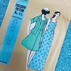 May include: A tan paper sewing pattern envelope labeled Family Circle Exclusive Pattern No. 41b Multi Pattern. The illustration shows two outfits: a solid light green jacket and dress set, and a long blue dress with a small floral print pattern.