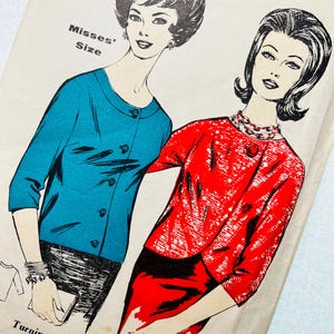 May include: Vintage sewing pattern featuring illustrations of two women in stylish outfits. One woman wears a teal cardigan, while the other is in a red jacket and skirt. The pattern is labeled "Misses' Size" and includes the text "Turnings are allowed on this pattern."