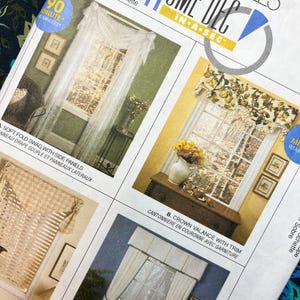 May include: A McCall's Home Dec sewing pattern envelope featuring illustrations of window treatments including a soft fold swag with side panels, a crown valance with trim, and various curtain styles with tie-backs for home decor projects.