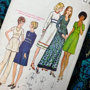 May include: A white sewing pattern envelope for size 12, bust 86cm, featuring illustrations of four different dress and pant styles. The text includes CUTTING LAYOUTS WITH YARDAGES FOR 35" FABRIC ENCLOSED and shows technical line drawings of the garments.