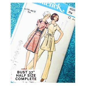 May include: Vintage sewing pattern featuring illustrations of two women in dresses and pantsuits. The pattern includes the text "SIZE 14 1/2 BUST 37" and "HALF SIZE COMPLETE". The pattern is on a blue floral background.