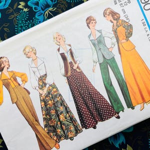 May include: A sewing pattern envelope featuring illustrations of four different outfits, including vests, blouses, trousers, and skirts in various colours and patterns like polka dots and floral prints, with text indicating a bust size of 87 cm (34 inches).