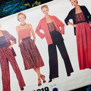 May include: A vintage sewing pattern featuring four women modeling different outfits. The outfits include a skirt, pants, and dresses in shades of red, black, and pink. The pattern is on a white background with the number "345" visible.