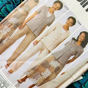 May include: A sewing pattern envelope featuring illustrations of various outfits including a button-down jacket, striped trousers, and a patchwork skirt. The text includes the brand name Simplicity and the American Sewing Guild logo.