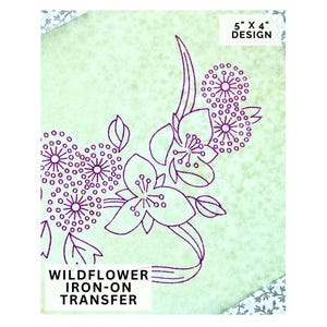 May include: A light green iron-on transfer featuring a purple wildflower design. The design is 5" x 4" and includes the text "WILDFLOWER IRON-ON TRANSFER". The floral illustration includes detailed outlines of flowers and circular accents.