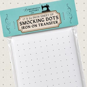 May include: A 17 x 24 inch sheet of smocking dots iron-on transfer by Serendipity Pattern Co. The product is packaged in a clear plastic sleeve with a light blue header card featuring a black sewing machine icon and black text.