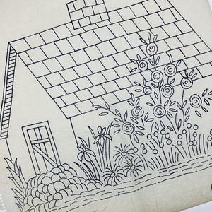 May include: A black and white line drawing on off-white paper depicting a cottage with a tiled roof, a chimney, and a door. The scene includes a garden with various stylised flowers, circular blossoms, and foliage. A red stamp reads Made in England.