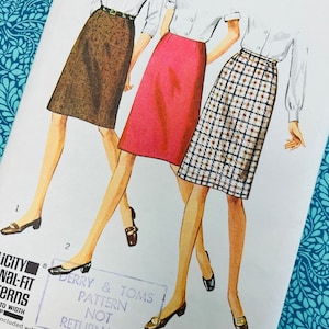 May include: A vintage Simplicity sewing pattern showing illustrations of three skirts in various designs. The pattern includes measurements for a 74 cm waist and 102 cm hips. The text "Derry & Toms Pattern Not Returnable" is visible.
