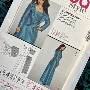 May include: A Burda Style sewing pattern showing a teal suit and dress. The pattern includes garment illustrations, size charts, and the text "KOMBINATION COORDINATES COORDINADOS". Measurements are in cm.