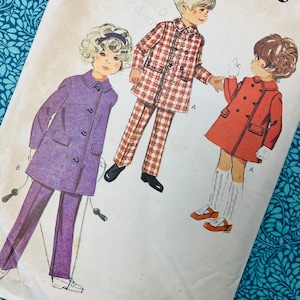 May include: A white ceramic mug with a black handle and the text "But First, Coffee" in a black, bold font. The mug is on a white surface.