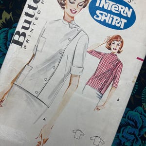 May include: Vintage Butterick printed pattern for an "Intern Shirt." The illustration shows a white shirt with a diagonal button closure and a red and white checkered shirt. The pattern includes sizes 10, 12, 14, and 16.