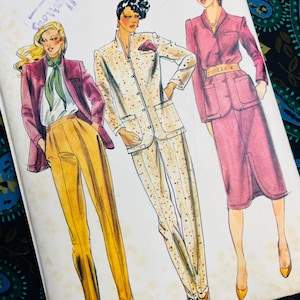 May include: A Butterick sewing pattern envelope featuring Willi Smith designs for size 12. The illustration displays three outfits: a magenta jacket with yellow trousers, a speckled cream suit with a jacket and trousers, and a magenta skirt suit.