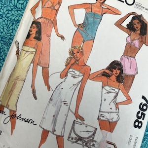 May include: Vintage McCall's sewing pattern 7958 featuring illustrations of lingerie designs. The pattern cover displays various styles of slips, camisoles, and shorts in soft pastel colors. The pattern includes sizes 12-14-16.