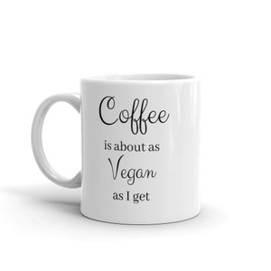 May include: White ceramic coffee mug with black text that reads "Coffee is about as Vegan as I get".