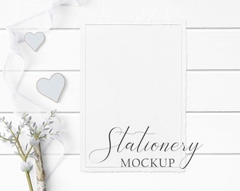 5x7 Stationery Mockup Styled with rustic wood, textured paper, flowers, white ribbon, and rustic accents on a white wood background.