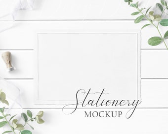5x7 Stationery Mockup Styled with textured paper, greenery, white ribbon, and stamp seal on a white wood background.