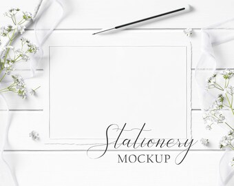 5x7 Stationery Mockup Styled with rustic wood, textured paper, flowers, white ribbon, and white wood pencil on a white wood background.