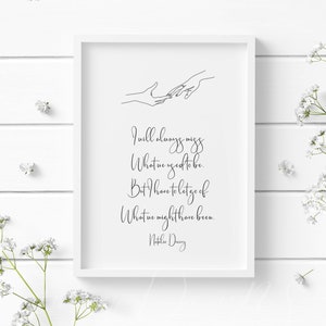 May include: A framed white print with black text and a line drawing of two hands reaching out. The text reads: "I will always miss what we used to be. But I have to let go of what we might have been." Signed "Natalie Davey."